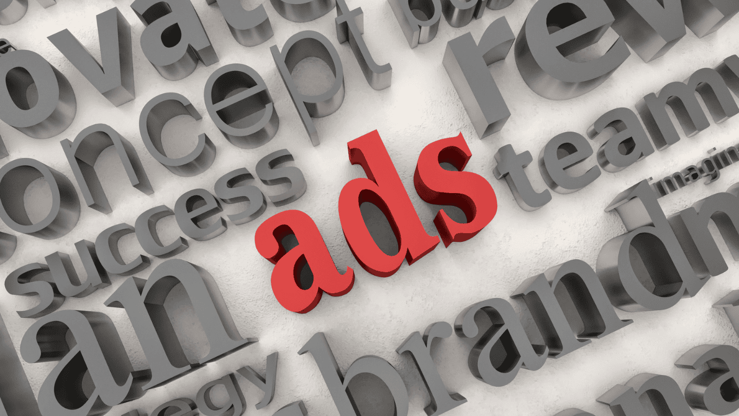 White rectangle background with gray raised marketing words, most of which are not readable, with the word ads in red in the middle.
